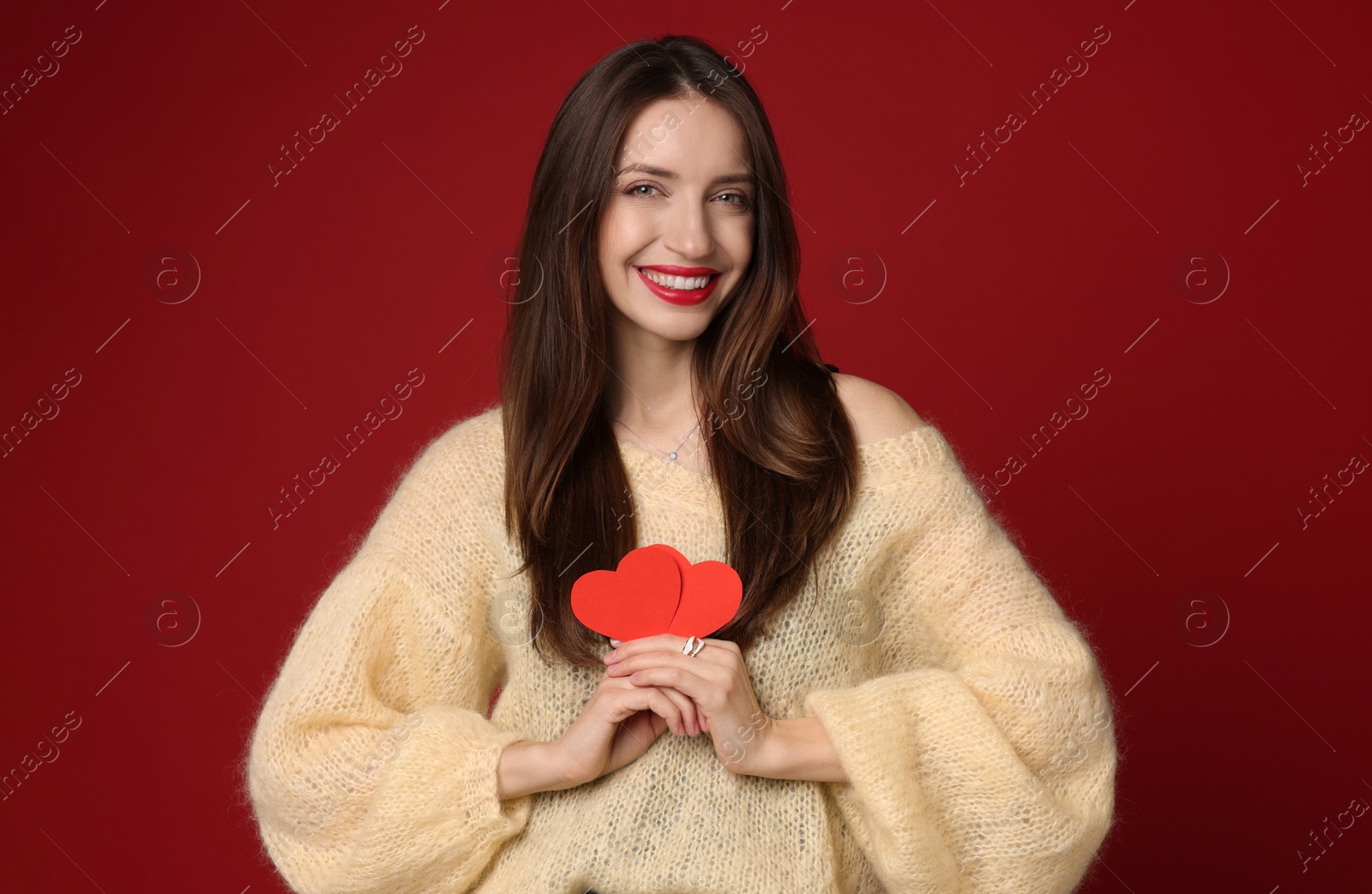 Photo of Happy Valentine's Day. Beautiful woman with paper hearts on red background