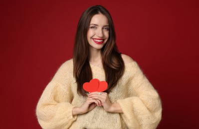 Photo of Happy Valentine's Day. Beautiful woman with paper hearts on red background