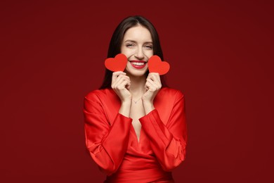 Photo of Happy Valentine's Day. Beautiful woman with paper hearts on red background