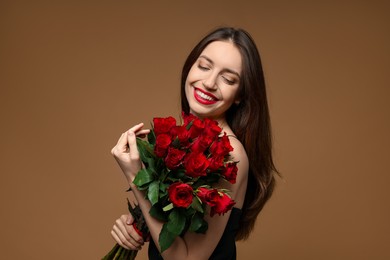 Photo of Happy Valentine's Day. Beautiful woman with bouquet of roses on brown background