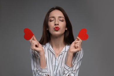 Photo of Happy Valentine's Day. Beautiful woman with paper hearts on grey background