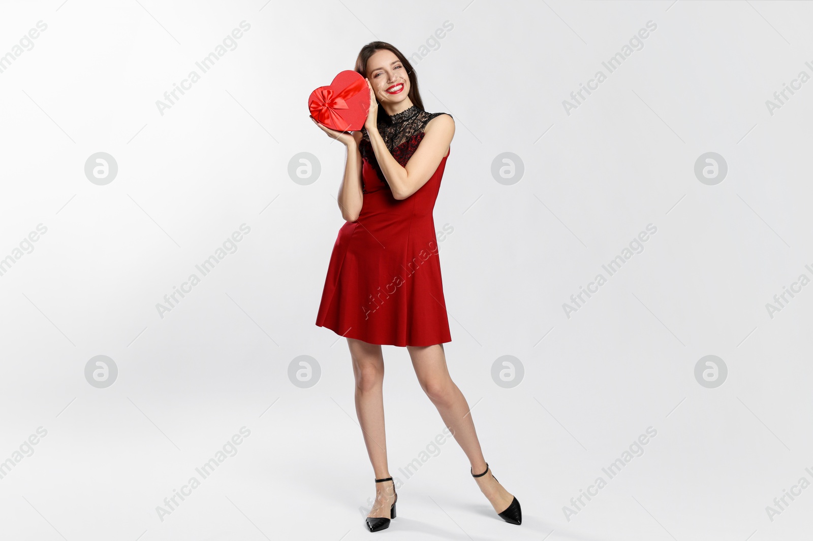 Photo of Happy Valentine's Day. Beautiful woman with heart shaped gift box on white background