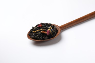 Photo of Dry tea leaves in spoon on white background