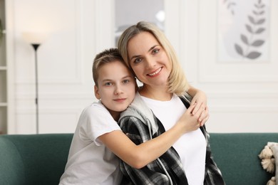 Photo of Mother and son on sofa at home