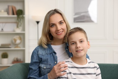 Photo of Mother and son on sofa at home