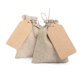 Photo of Burlap bags with tags isolated on white