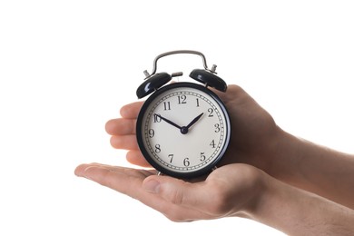 Man with black alarm clock on white background, closeup