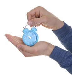 Photo of Man with light blue alarm clock on white background, closeup