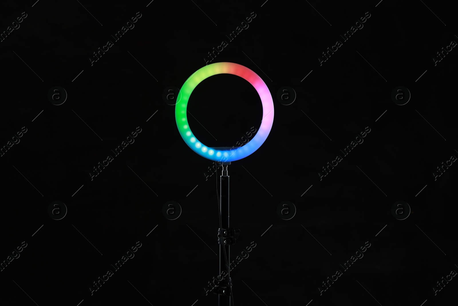 Photo of Ring lamp on stand against black background