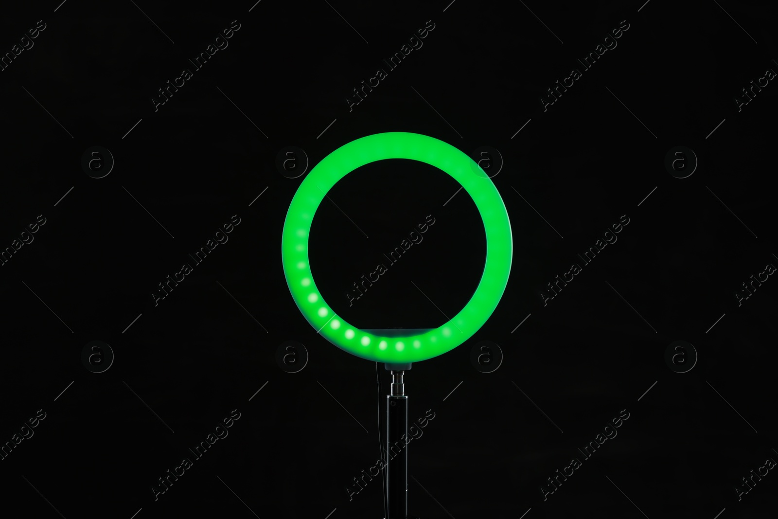 Photo of Ring lamp on stand against black background