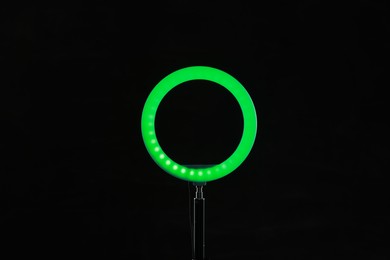 Photo of Ring lamp on stand against black background