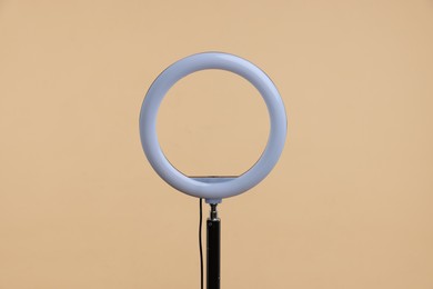 Photo of Ring lamp on stand against beige background