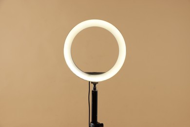 Photo of Ring lamp on stand against beige background