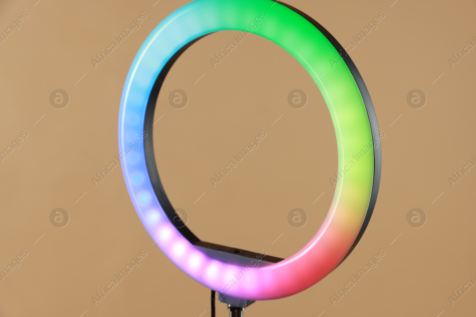 Photo of One ring lamp on beige background, closeup