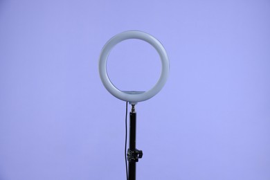 Photo of Ring lamp on stand against purple background