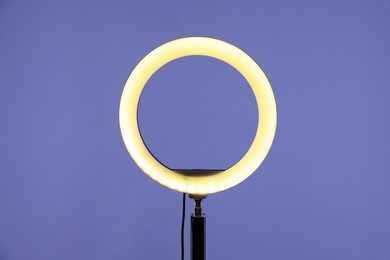 Photo of Ring lamp on stand against purple background