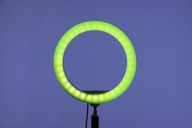 Photo of Ring lamp on stand against purple background