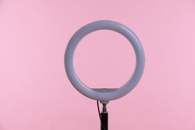 Photo of Ring lamp on stand against pink background