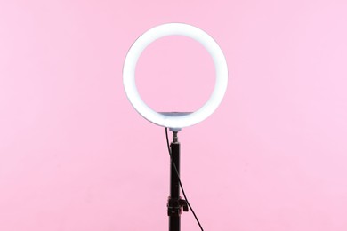 Photo of Ring lamp on stand against pink background