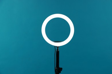 Photo of Ring lamp on stand against light blue background