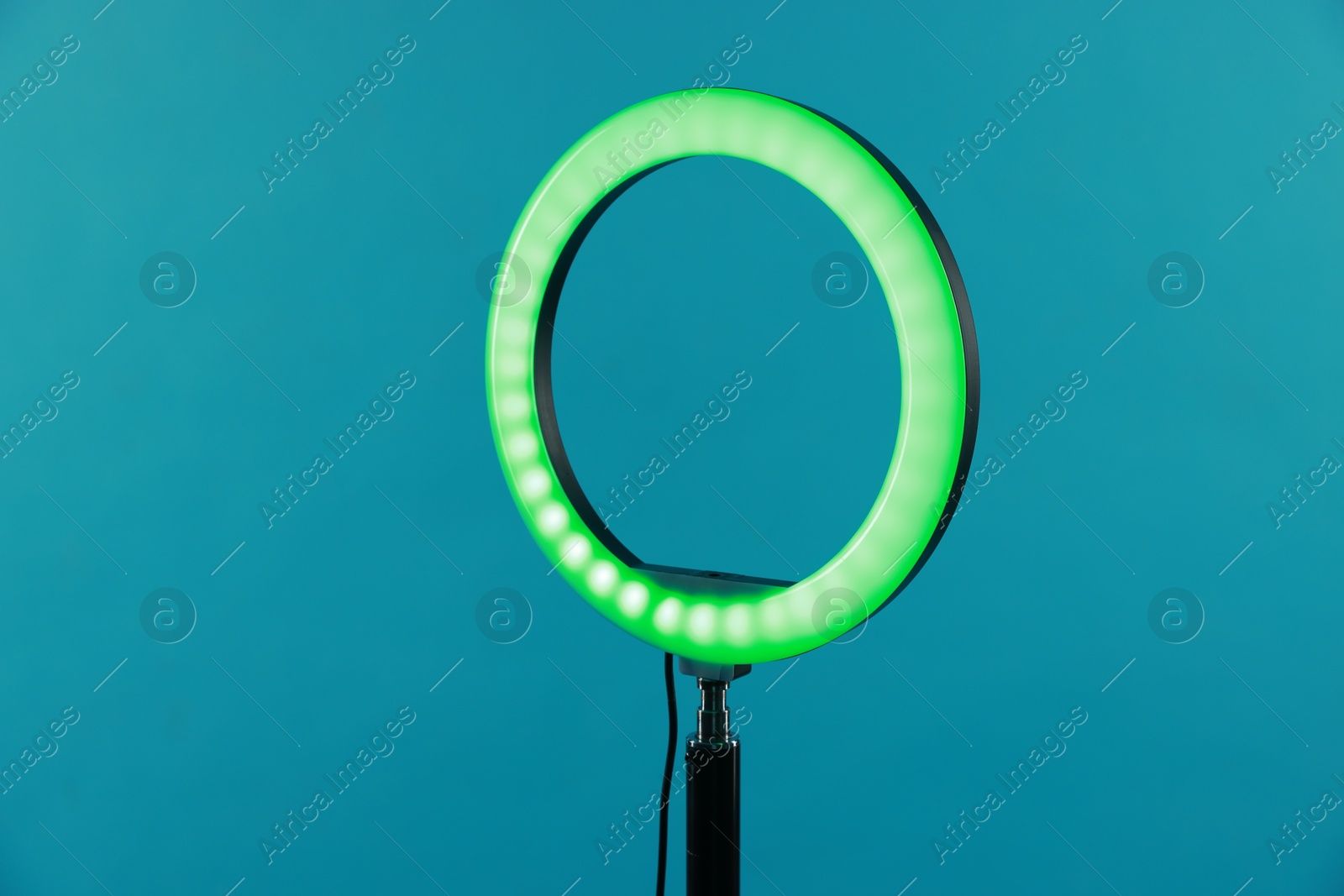 Photo of Ring lamp on stand against light blue background