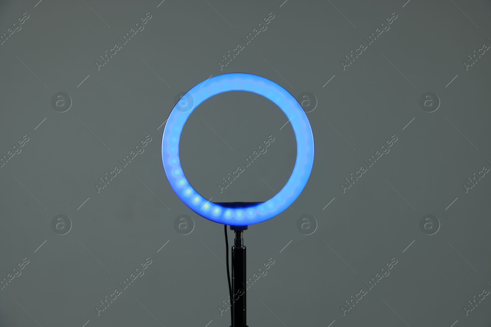 Photo of Ring lamp on stand against grey background