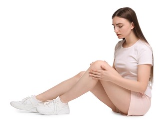 Photo of Young woman suffering from pain in knee on white background