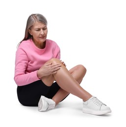 Senior woman suffering from knee pain on white background