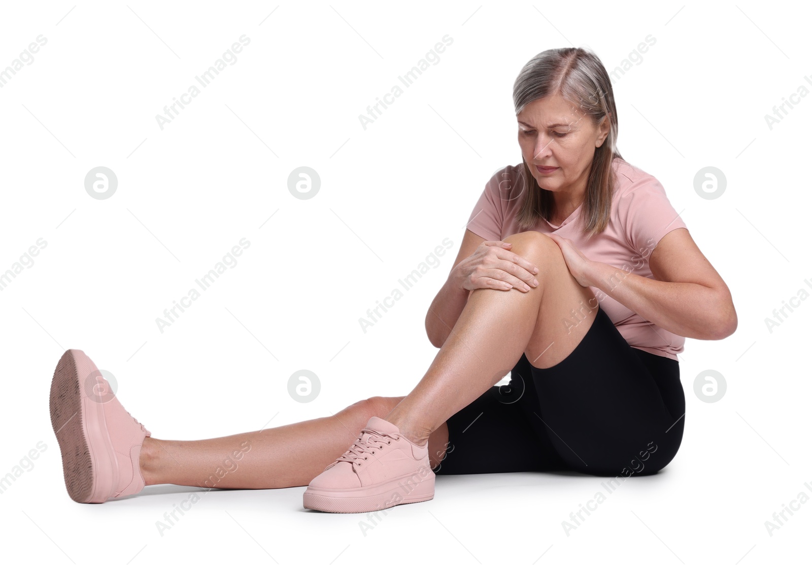 Photo of Senior woman suffering from knee pain on white background