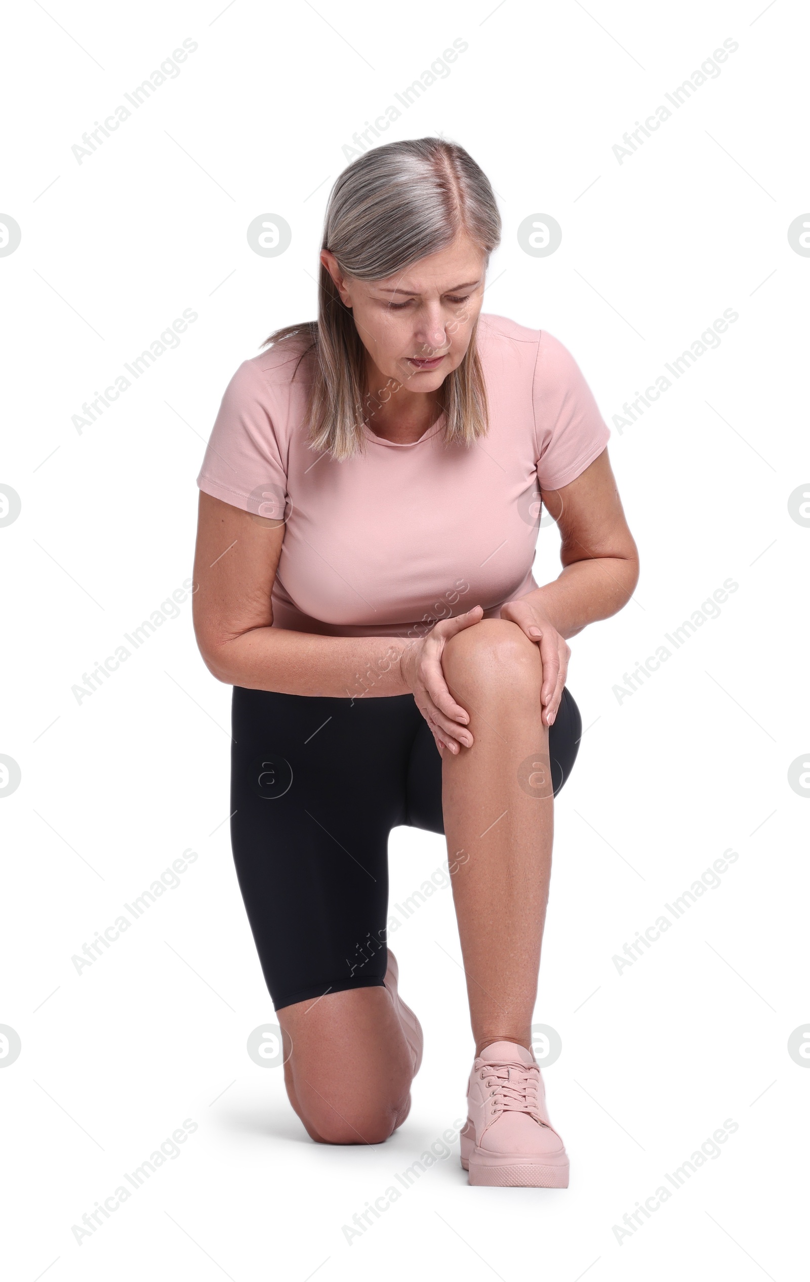 Photo of Senior woman suffering from knee pain on white background