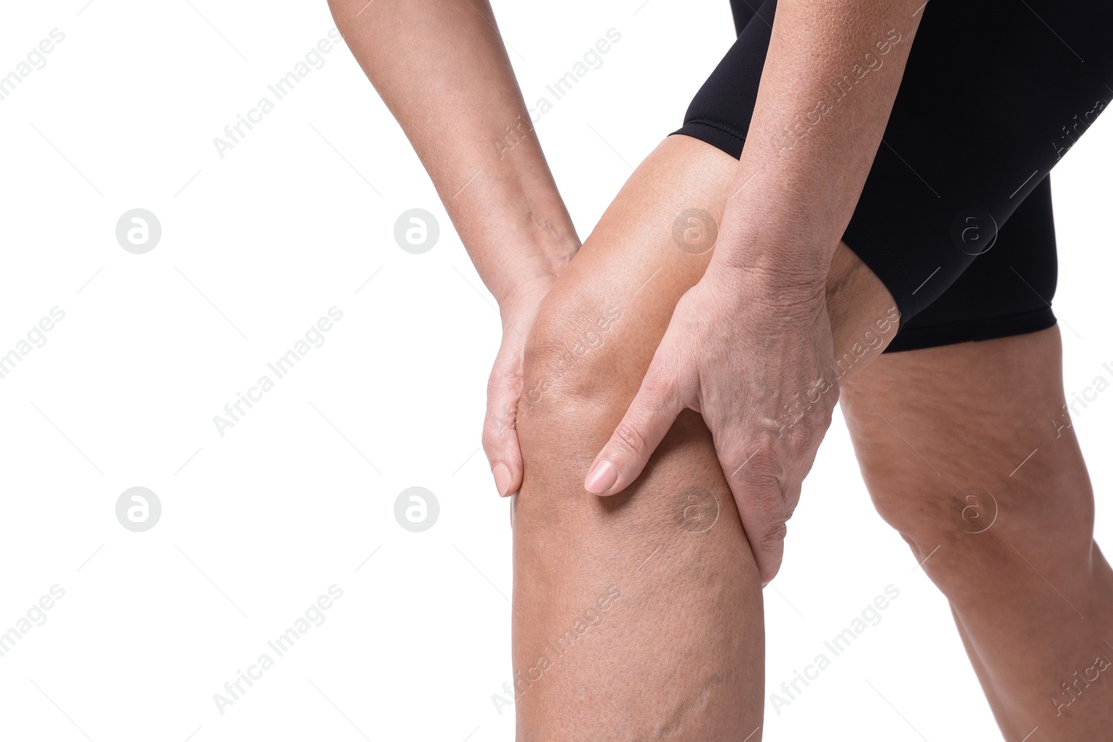 Photo of Woman suffering from pain in her knee on white background, closeup