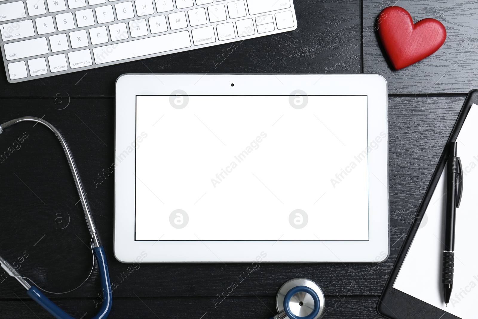 Photo of Cardiology. Flat lay composition with stethoscope and tablet on black wooden table