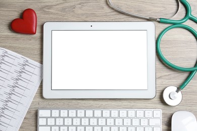 Photo of Cardiology. Flat lay composition with stethoscope and tablet on wooden table