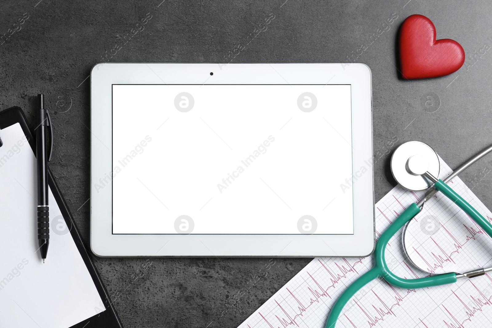 Photo of Cardiology. Flat lay composition with stethoscope and tablet on gray textured table