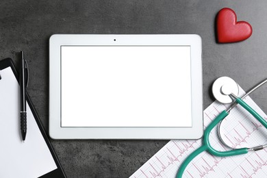 Photo of Cardiology. Flat lay composition with stethoscope and tablet on gray textured table