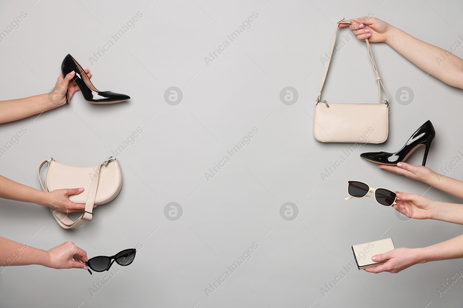 Photo of Women with stylish accessories and shoes on light grey background, closeup. Space for text