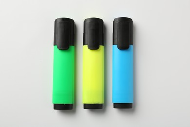 Photo of Bright highlighters on white background, flat lay