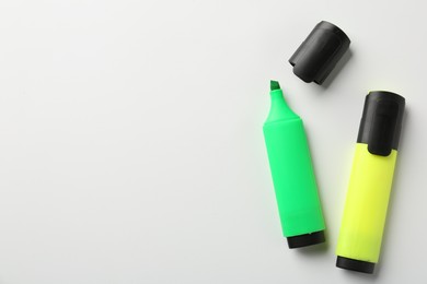 Photo of Bright highlighters on white background, flat lay. Space for text