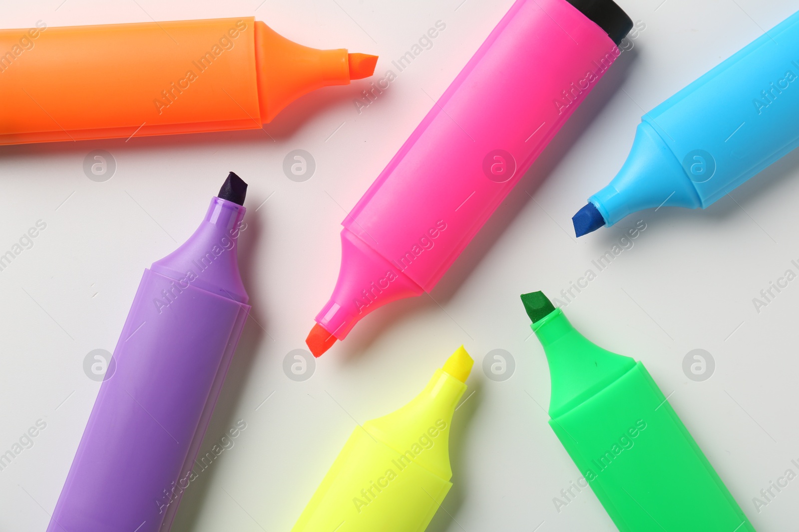 Photo of Bright highlighters on white background, flat lay