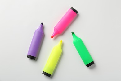 Photo of Bright highlighters on white background, flat lay