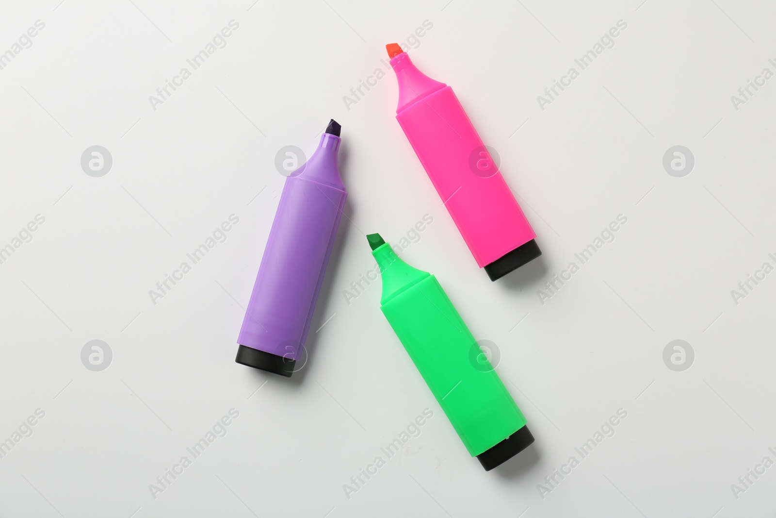 Photo of Bright highlighters on white background, flat lay