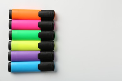 Photo of Bright highlighters on white background, flat lay. Space for text