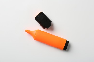 Photo of Bright highlighter and cap on white background, flat lay