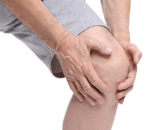 Photo of Senior man suffering from knee pain on white background, closeup