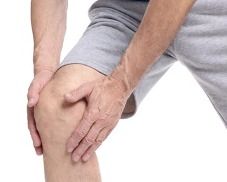 Photo of Senior man suffering from knee pain on white background, closeup