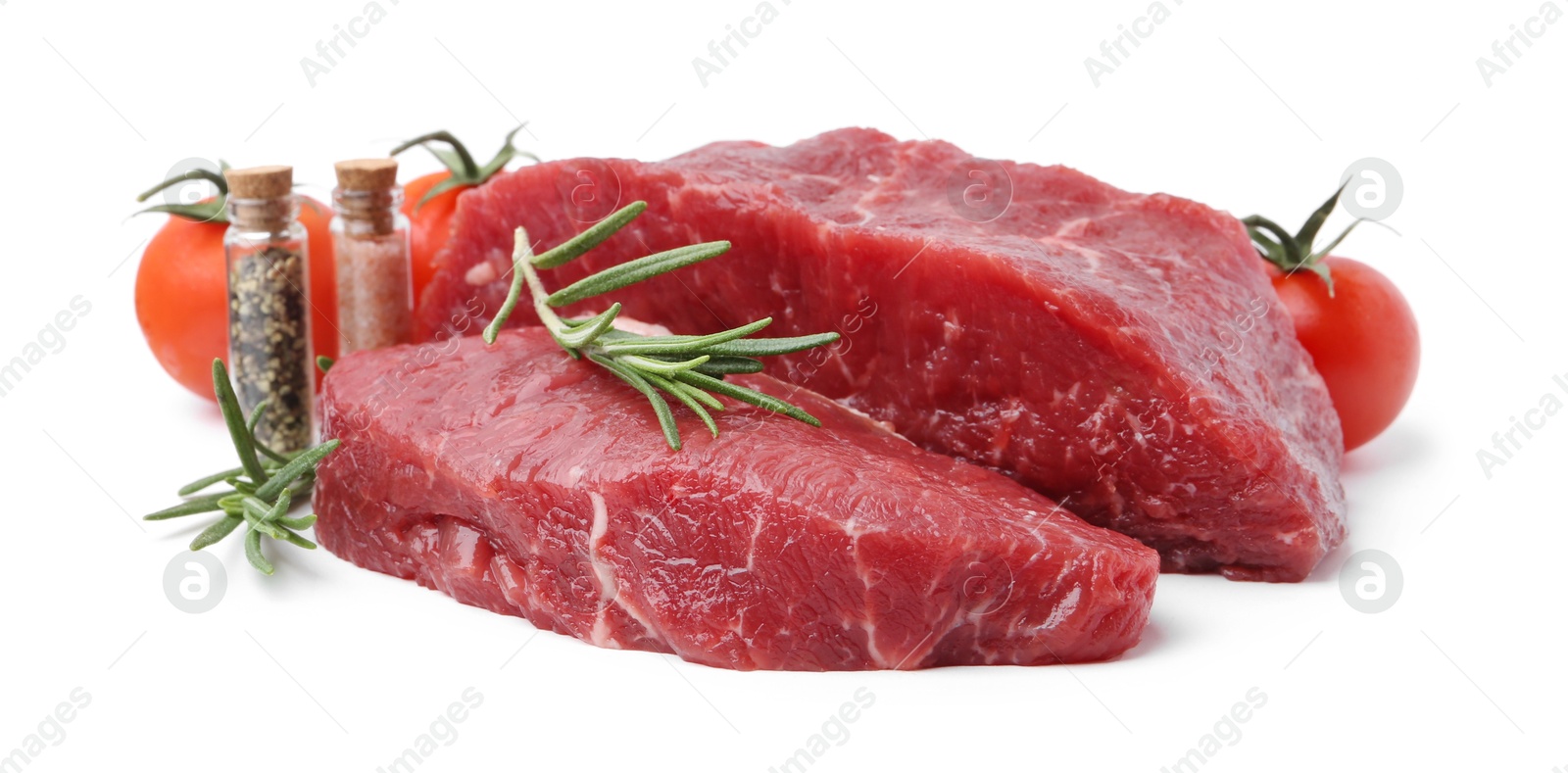 Photo of Pieces of raw beef meat, spices and tomatoes isolated on white