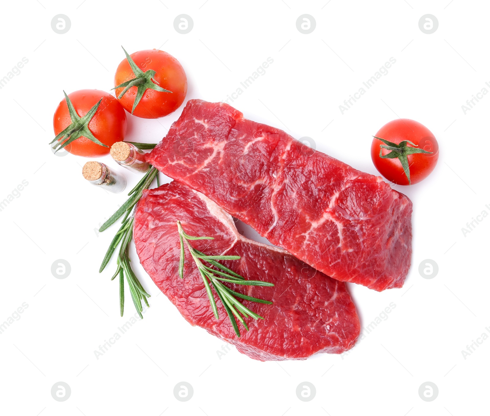 Photo of Pieces of raw beef meat, spices and tomatoes isolated on white, top view