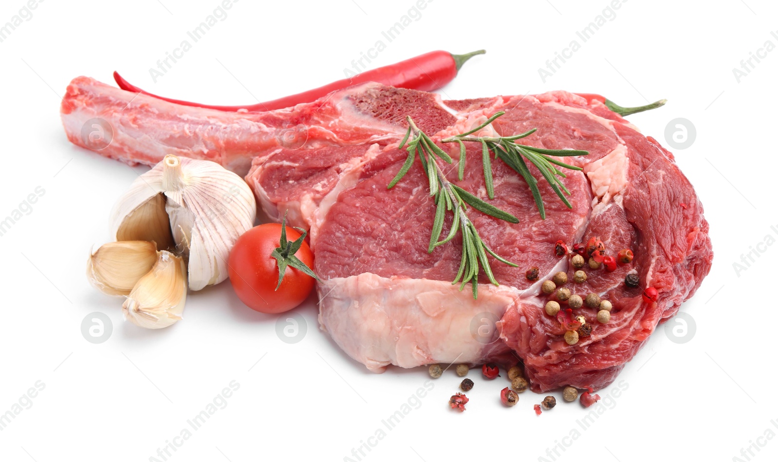 Photo of Piece of raw beef meat, spices and tomato isolated on white