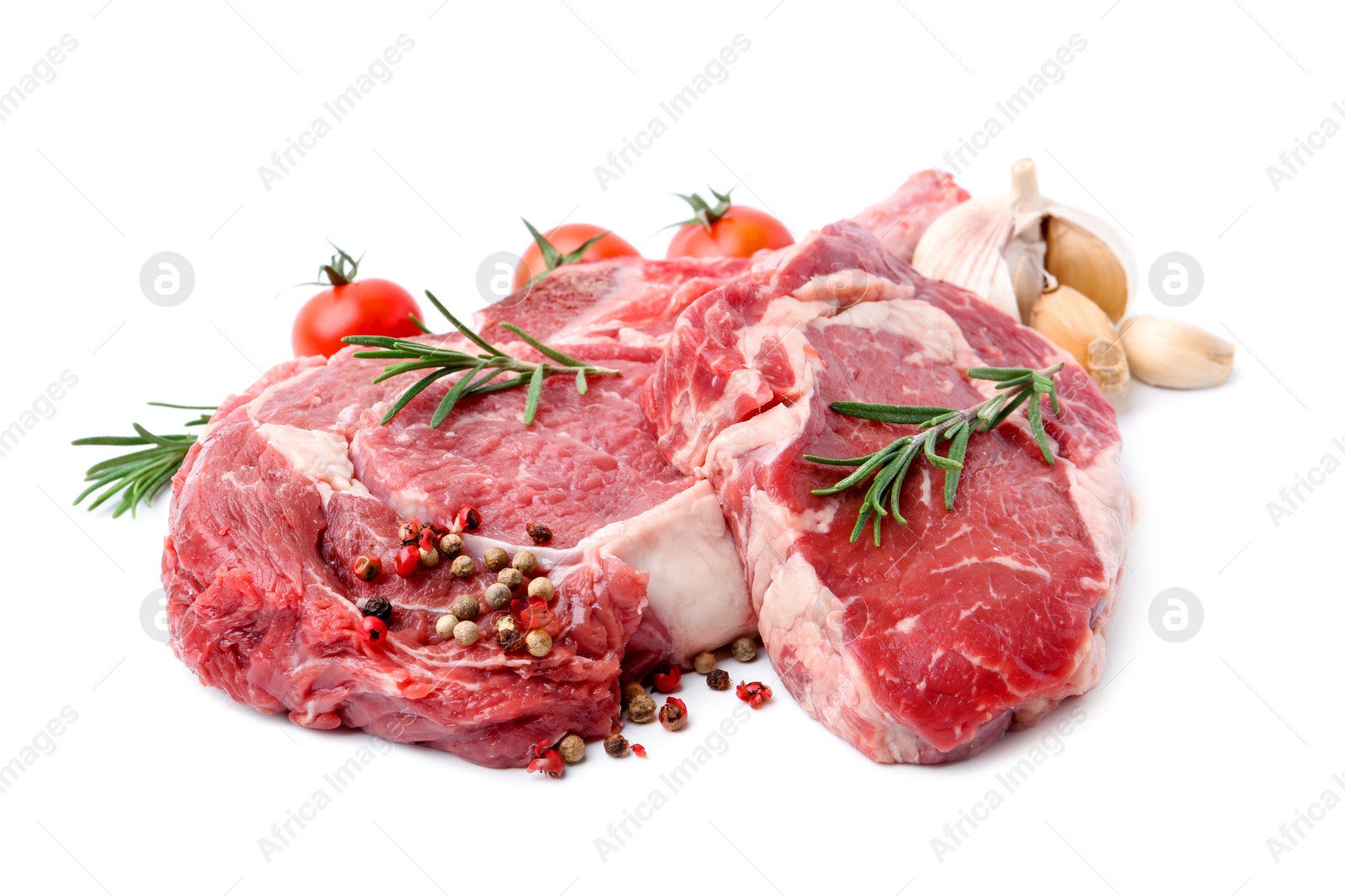 Photo of Pieces of raw beef meat, spices and tomatoes isolated on white