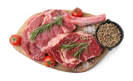 Photo of Pieces of raw beef meat, spices and tomatoes isolated on white, top view